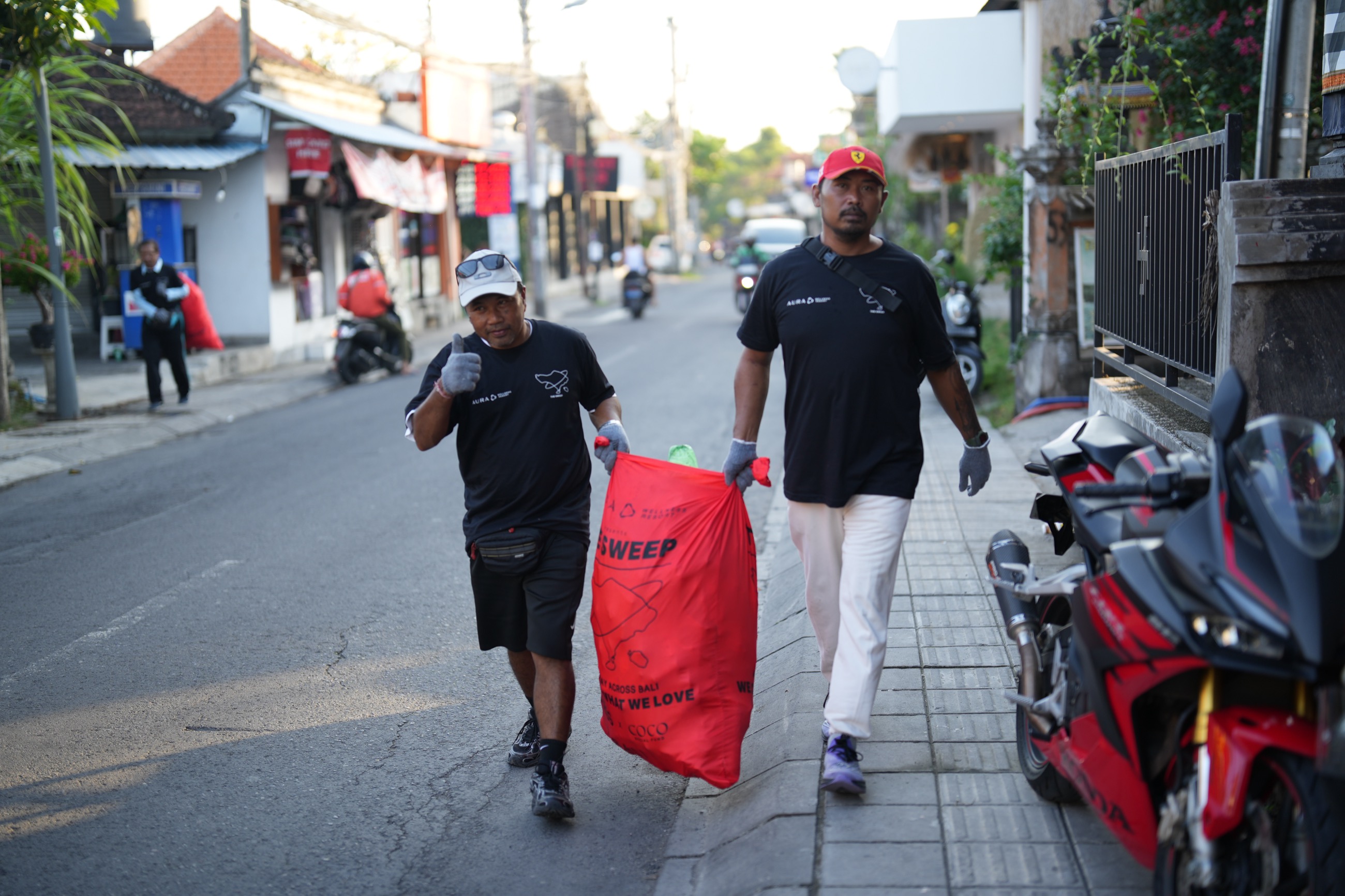 The BLESS Sweep team on the streets of Bali with red clean-up bags